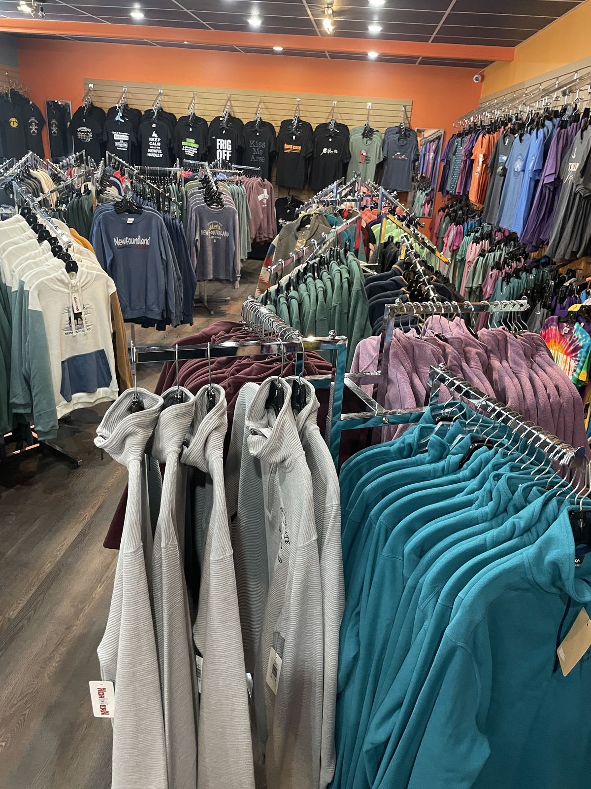 Racks of Newfoundland-branded hoodies and apparel in the Downhome Shoppe